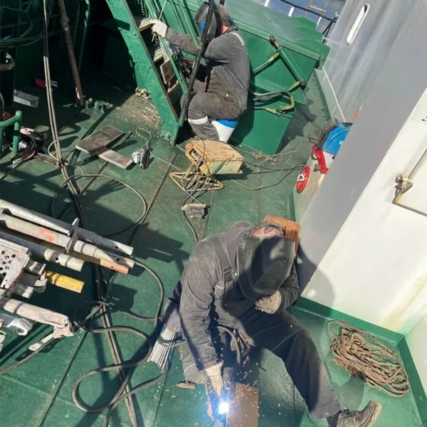 Onboard repair team with welders carrying out deck steel welding on a vessel