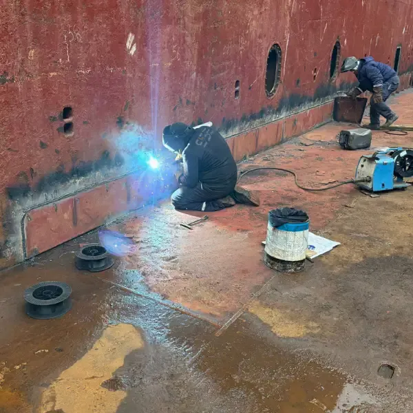 Welder performing structural steel welding on an internal vessel structure