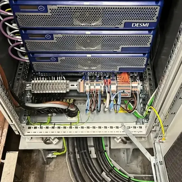 Marine electrical control cabinet with terminal blocks and wiring onboard a vessel