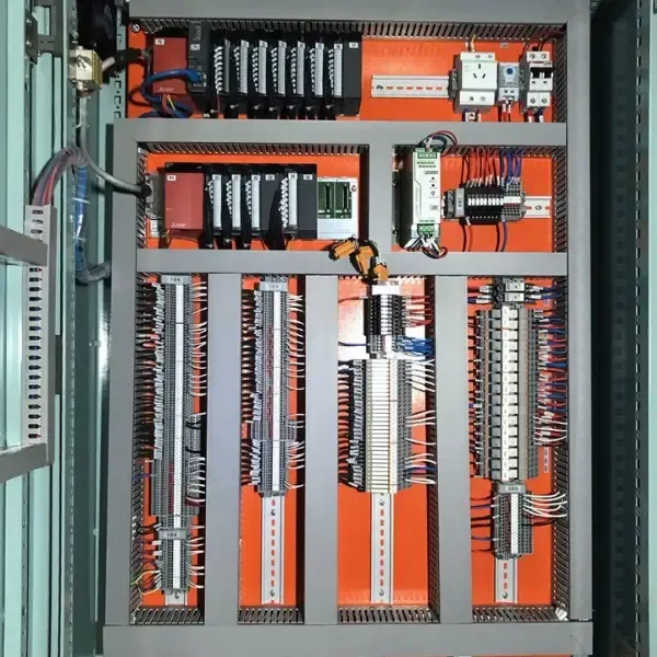 Automation control cabinet with PLC modules, relays and terminal wiring