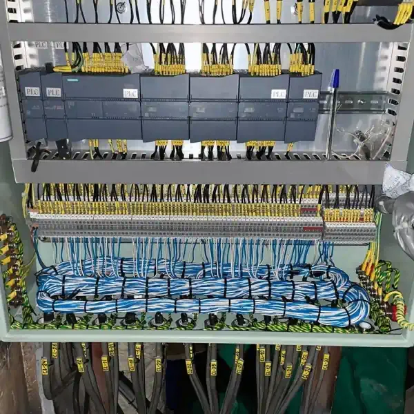 PLC control panel with terminal blocks and organised electrical wiring
