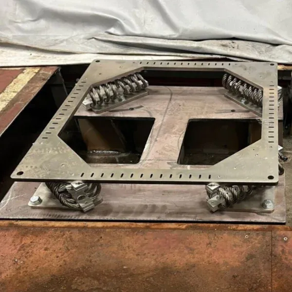 Fabricated steel plate component with cut-outs and bolt holes prepared in workshop for ship repair and dry dock support.