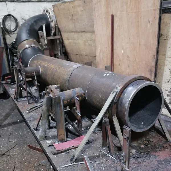 steel pipe spool in workshop during marine piping fabrication and welding preparation for ship repair.